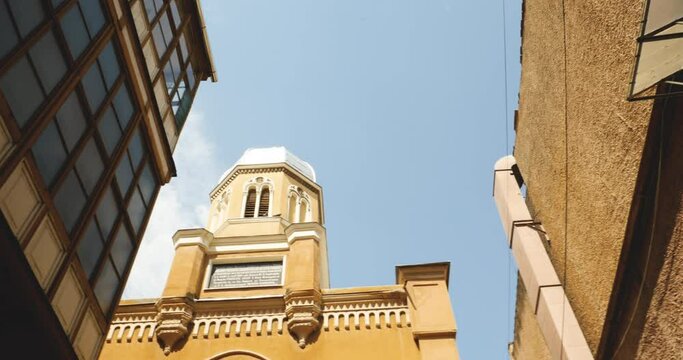 Pan over the tower of Biserica Sfanta Adormirea Maicii Domnului Church of the Holy Dormition of the Mother of God to old fresque with biblical scene