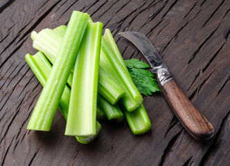Pile of celery ribs isolated on white background.