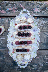 Dessert Anna Pavlova with fresh blackberries and buttercream.