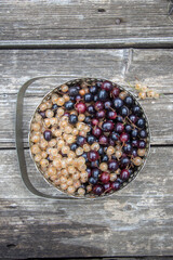 black and white currants in a metal vase.