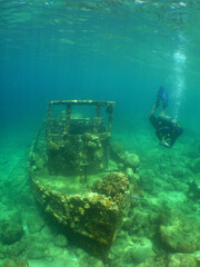 a small sunken ship in the crystal clear waters of the caribbean sea