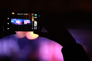 Live concert shown through a phone screen