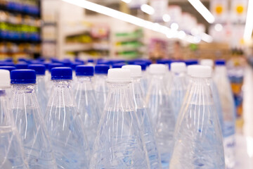 water bottles with blue caps in supermarket