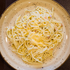 portion of spaghetti carbonara on a plate in a restaurant. top view