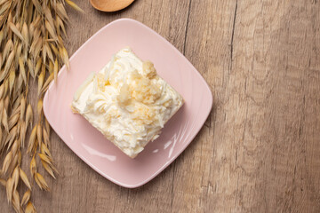 Sliced delicious vanilla cake on wooden background