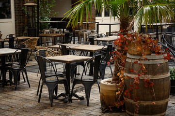 Beautiful interior of the restaurant's summer terrace. Empty restaurant interior. Chairs tables of...