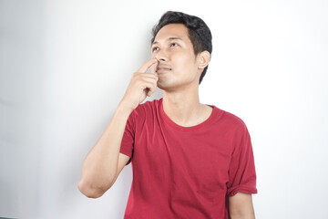man picking his nose and looking upward