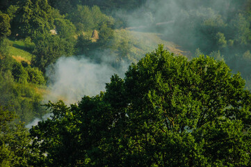 Summer landscape with smoke on the background of nature