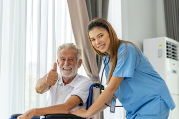 Obraz premium Man being cared for by a private Asian nurse at home suffering from Alzheimer's disease to closely care for elderly patients with copy space on left