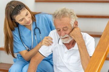 Fototapeta premium Man being cared for by a private Asian nurse at home suffering from Alzheimer's disease to closely care for elderly patients with copy space on left