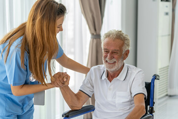 Man being cared for by a private Asian nurse at home suffering from Alzheimer's disease to closely...
