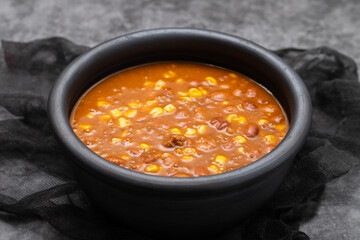 Mexican typical dish Chili Con Carne on black dish