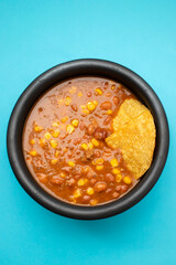 Mexican typical dish Chili Con Carne on black dish