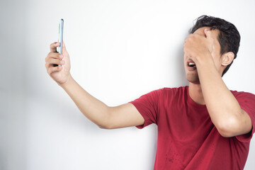 man is shocked to see social media on his cellphone displaying obscene or vulgar content so he...