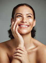 Skincare, beauty and dermatology woman with cream for acne, health and glow on a studio background....