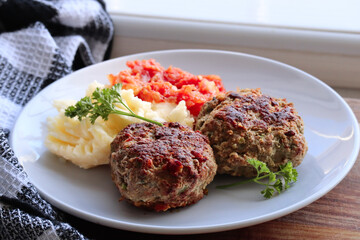 meatballs with mashed potatoes. South African frikkadels with mash and tomato sauce mix 