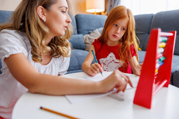 Mother helping daughter study math