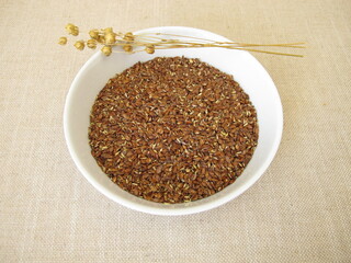 A bowl of coarsely ground brown flax seeds