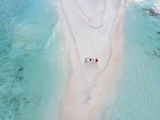 Young family on vacation have a lot of fun on the beach with a view from above.