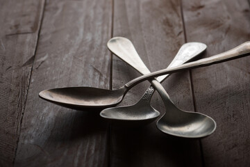 Metal spoons on a wooden table