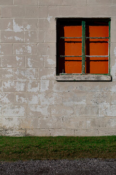 Broken Window On A Textured Concrete Block Wall