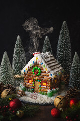 Log cabin gingerbread house decorated with candy for Christmas.