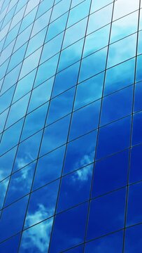 Blue sky and clouds mirroring over glass façade on New York City skyscraper, vertical background, timelapse