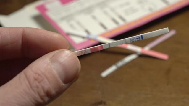 Man Check Pregnancy Test Strip With Negative Result - close up