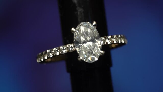 Beautiful Luxury Oval Solitaire Diamond ring on a dark background