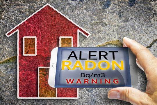 Portable information device for monitoring radioactive gas radon - radon testing concept image against a cracked wall