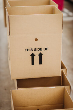 Cardboard boxes saying 'this side up'