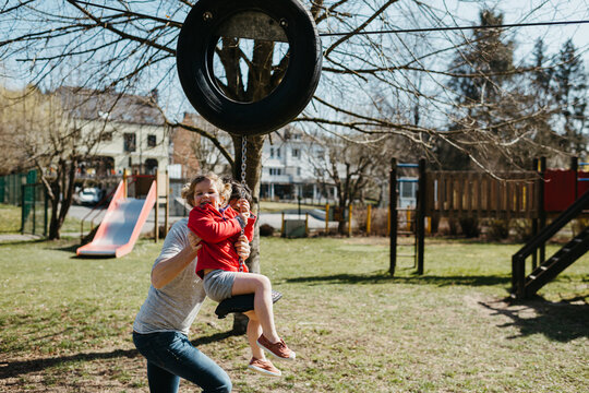 Kid Playing Rope Sliding With Father