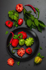 Green and red ribbed tomatoes, American or Florentine variety. Ripe vegetables, fresh bay leaves