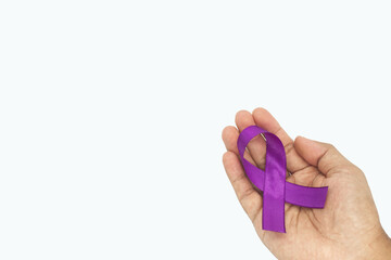 Hand holding purple ribbon on white background with copy s