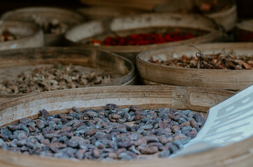 Coffee plantation in Bali, Indonesia. Plants, coffee leaves and seeds in woven baskets. 
