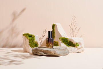 Unbranded natural cosmetic serum packaging standing on stone podium