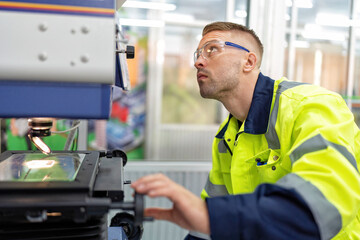 Engineer sitting in robot fabrication room use measuring microscope machine check microchip