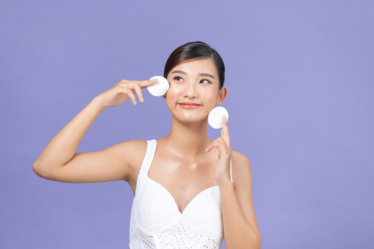 Young Woman Removing Makeup With Cleansing Pads