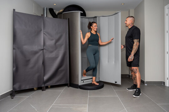 Athlete and coach near cryogenic chamber
