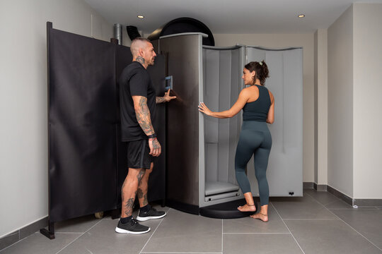 Athlete and coach near cryogenic chamber