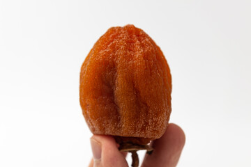 Half dried persimmon on a white background
