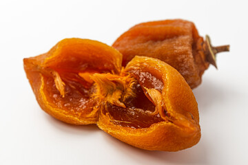 Half dried persimmon on a white background