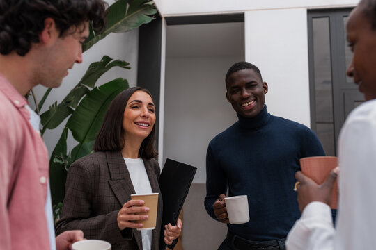 Happy diverse coworkers smiling and talking
