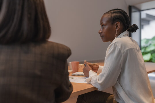 Black businesswoman during meeting in boardroom