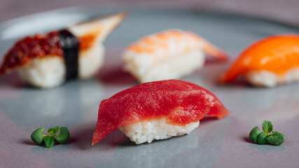 Close up of sashimi sushi set with chopsticks and soy, different sushi rolls on plate