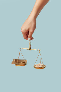 Gold ingots and wheat grain weighed on scales.