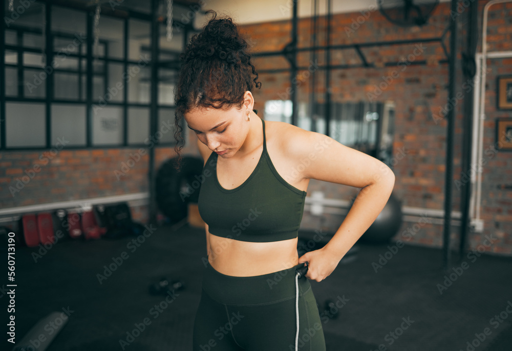 Sticker Fitness, exercise and woman at gym to check body progess after training for health, balance and wellness. A young sports female or athlete strong and healthy while on diet and active to lose weight