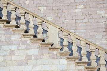 Detail of an historical and monumental old italian chiseled stone staircase with balustrade
