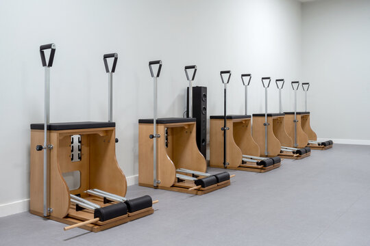Pilates chairs in row near wall