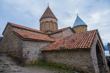 Fototapeta premium Ananuri, Georgia : 20-11-2022 : amazing view of the Ananuri castle complex with church on the Aragvi River in Georgia in a cloudy day. Ananuri Castle is located close Tbilisi.